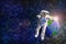 Statue or plastic model astronaut or spaceman floating in colorful space galaxy with earth or blue green planet and fair light