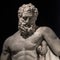 Statue of powerful Hercules, closeup, isolated at black background