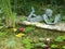 Statue of a reading young girl near a pond in Castillon garden in Normandy in  France.