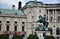 Statue with a rider on a prancing horse, located in front of the facade, of a historic building, in the museum district in Vienna.