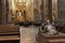 Statue of ruler and his servants inside St. Vitus Cathedral without people with benches