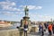 The statue of Saint John of Nepomuk above the bronze plaques thought to bring good luck on Charles Bridge in Prague, Czechia