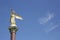 Statue or Sculpture Good angel of the world on the blue sky in Lazarevsky Sochi. Gilded figure with outstretched wings in the hand