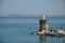 A statue in the sea and fishing boats on the island of Procida, Naples / Italy