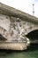 Statue sitting on a support bridge Invalides.