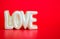 Statue spelling the word LOVE on a red background