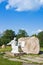 Statue of St. Moses near stone in beautiful park near St. Anne`s Church in Mosar, Belarus