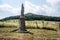 Statue of Sv. Antonin Paduansky near Kocourov village in Ceske Stredohori with young orchard and hill on the background