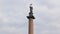 Statue on top of Alexander Column in Palace square in Saint Petersburg against cloudy sky