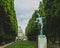 Statue between trees with Pantheon in the distance, in Luxembourg Gardens in Paris, France