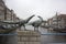 Statue of two pheasants on the bridge at dusk against the background of typical Dutch houses