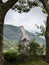 A statue of the Virgin Mary in the small Lunigiana town of Fivizzano, outdoors, framed by trees. Rural faith.