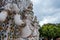 Statue at Wat Arun Ratchavararam, river side temple with a landmark spire.