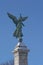 Statue of winged Goddess of Liberty on a blue sky