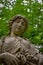 Statue of Woman Gazing Down at Cemetery