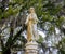 Statue of a Woman Under Moss Covered Oak Trees