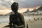 Statue of the writer Clarice Lispector with her dog `Ulisses` in the `Fishermen`s Way` with the sea in the background on the beach