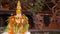 Statue in yard of aged oriental temple. White statue with colorful garlands in stone yard of Buddhist temple, Nepal.