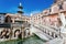 Statues of animals and stairs of the 16th century Praetorian Fountain under bright sun