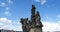 Statues on Charles bridge against blue sky