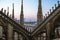 Statues and decorative elements on the roof of the Duomo. Evening Milan, view of the city from the terrace of the Duomo