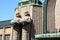 Statues holding spherical lamps in Helsinki railway station