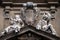 Statues of Hope and Poverty seated either side of the arms of the Theatine order, Santi Michele e Gaetano church in Florence