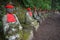 Statues of Ksitigarbha bodhisattva Jizo with red caps and bibs in Nikko, Japan