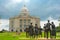 The statues of the Little Rock Nine face the State Capital Building as a storm rolls in