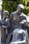 Statues of mourning at the graves of the monumental cemetery in Milan.