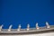 Statues standing on the roof of St. Peter`s Basilica in Vatican. Italy.