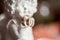 Statuette of an angel with wedding golden rings.