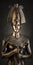 Statuette of the Egyptian pharaoh Tutankhamun on a brown background