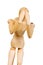 Statuette figure wooden man human makes shows experiences emotional action on a white background.