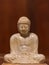 Statuette of Gautama Buddha in light marble in a prayer position