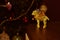 Statuette of a golden sheep on the background of a Christmas tree