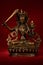 Statuette of Manjushri brandishing sword of wisdom on a red back
