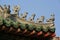 Statuettes of fantastic animals decorate the ridgepole of a temple in Hoi An (Vietnam)