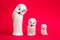 Statuettes of White Owls on Pink Background