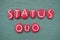 Status Quo, Latin phrase composed with red colored stone letters over green sand
