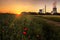 Staudinger coal-fired power plant, Bavaria, Germany. In the morning, sunrise with landscape, everything is reflected in a puddle