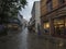 STAVANGER, NORWAY, SEPTEMBER 9, 2019 : street in city center of Stavanger with shops, restaurants and trees. Rainy moody