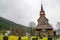 Stave church amidst graveyard in Norway on snowy day