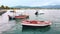 Stavros, Greece - September 26, 2020: Four old men resting on the beach with beached boats around, street on the background