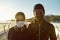 Stay active during quarantine. Young african couple in medical masks looking at camera after running together on the