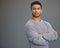 Stay determined. a handsome young man standing against a grey background.