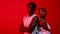 Stay determined. Red filtered shot of a sporty young man and woman posing together in the studio.