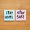 Stay at home and be safe. Self isolation and quarantine campaign to protect yourself and save lives. Handwritten.