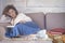 Stay at home for coronavirus epidemic quarantine concept - caucasian adult woman sit down on the sofa reading a book and enjoying
