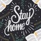 Stay home hand lettering with books and floral decoration, corona virus 2019-nCov motivation poster design with positive message